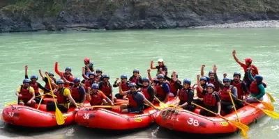 A team rafting together in red rafts on a river