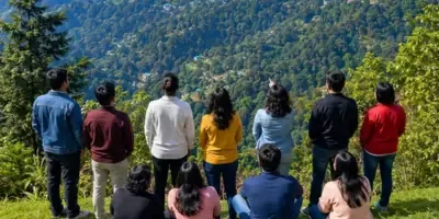 A group of friends looking out over forested hills