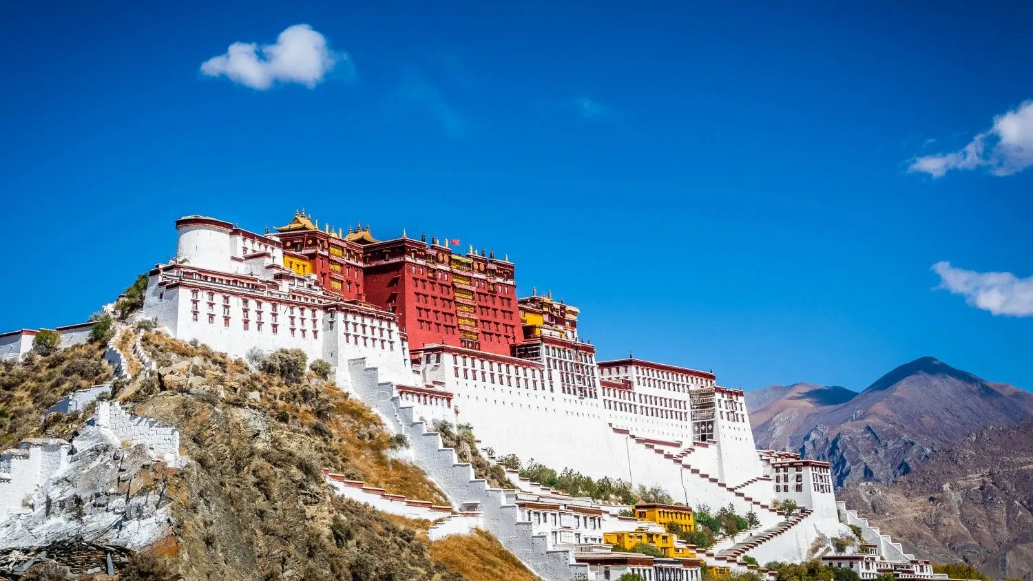 Mountain monastery beneath a clear blue sky
