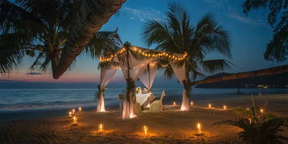 romantic dinner over a sandy beach